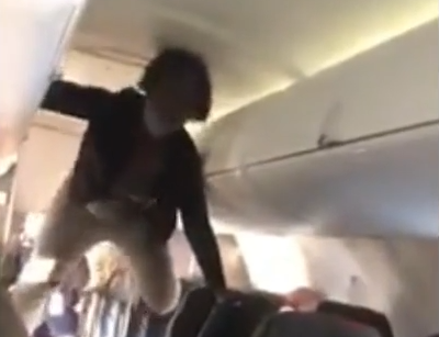 Flying In The Age Of COVID: Video Shows Demonic Woman Climbing Over Airplane Seats While Screaming, “Bitch, We Gonna Fuck All Night!”