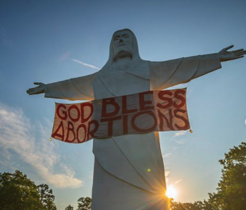Activists Hang “God Bless Abortions” Banner On 67-Foot Jesus Statue In Arkansas