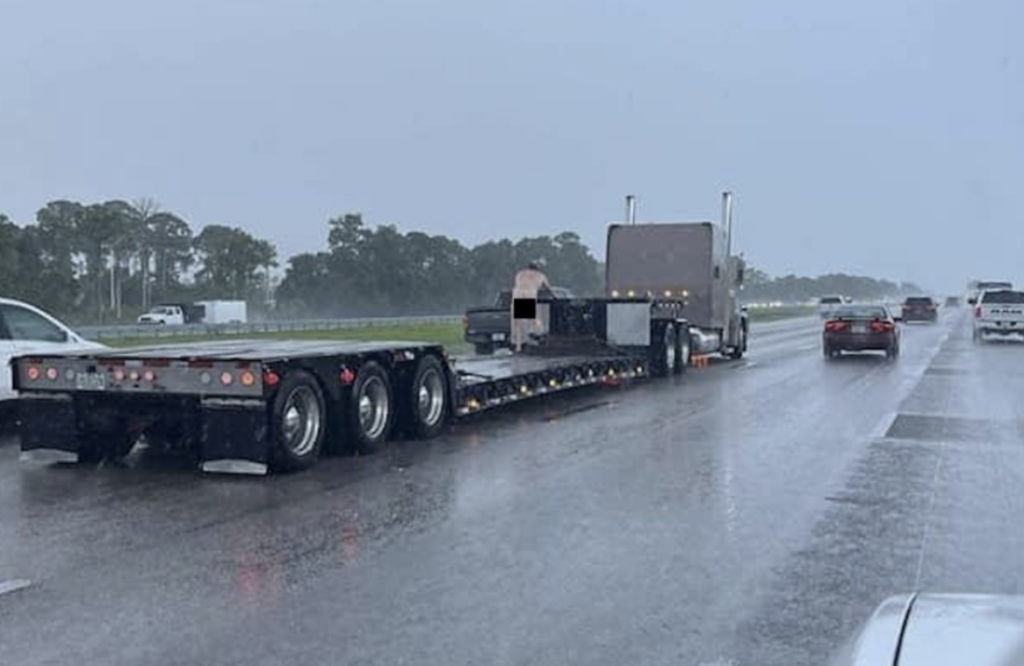 Naked Man Disrupts Traffic While Climbing Aboard Semi Truck Trailer